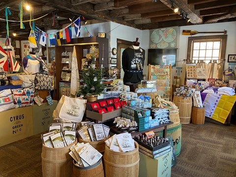 books, apparel, toys, maps and other souvenirs on display inside a store