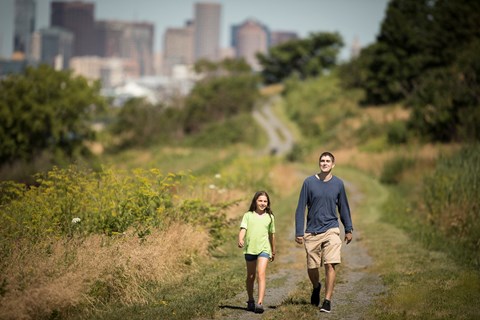 two people walking on a trail on Spectacle Island.