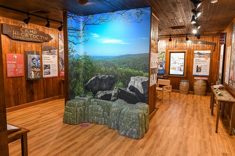 A large room with multiple history and nature exhibits with a central overlook display.