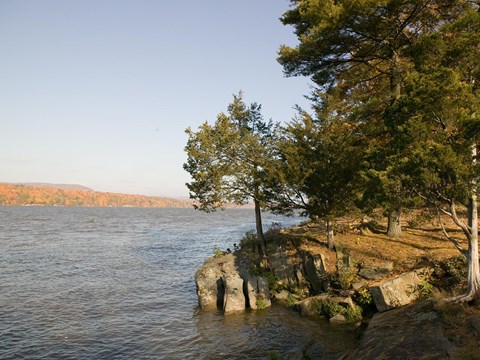 A River with a wooded setting in the foreground.
