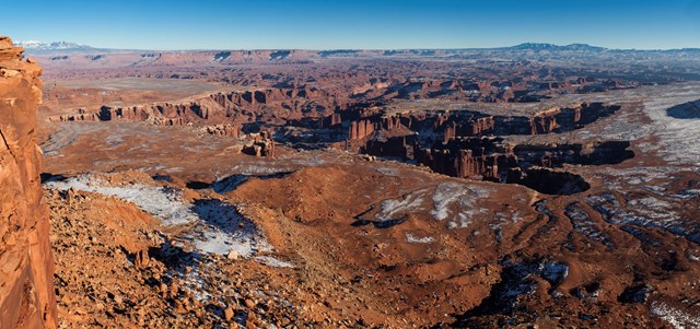 Snow dusting the tops of brown and red canyons seen from Grand View Point