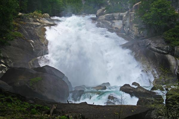 a large waterfall over a steep granite slope