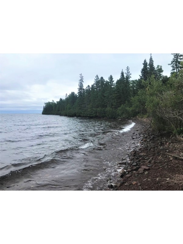 Forest and rocks make of a shoreline along Lake Superior.