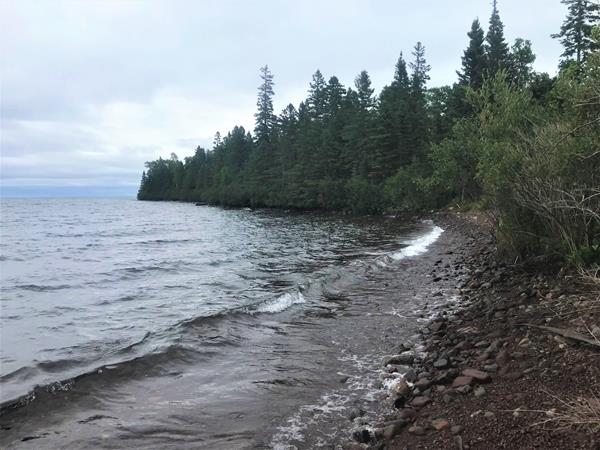 Forest and rocks make of a shoreline along Lake Superior.