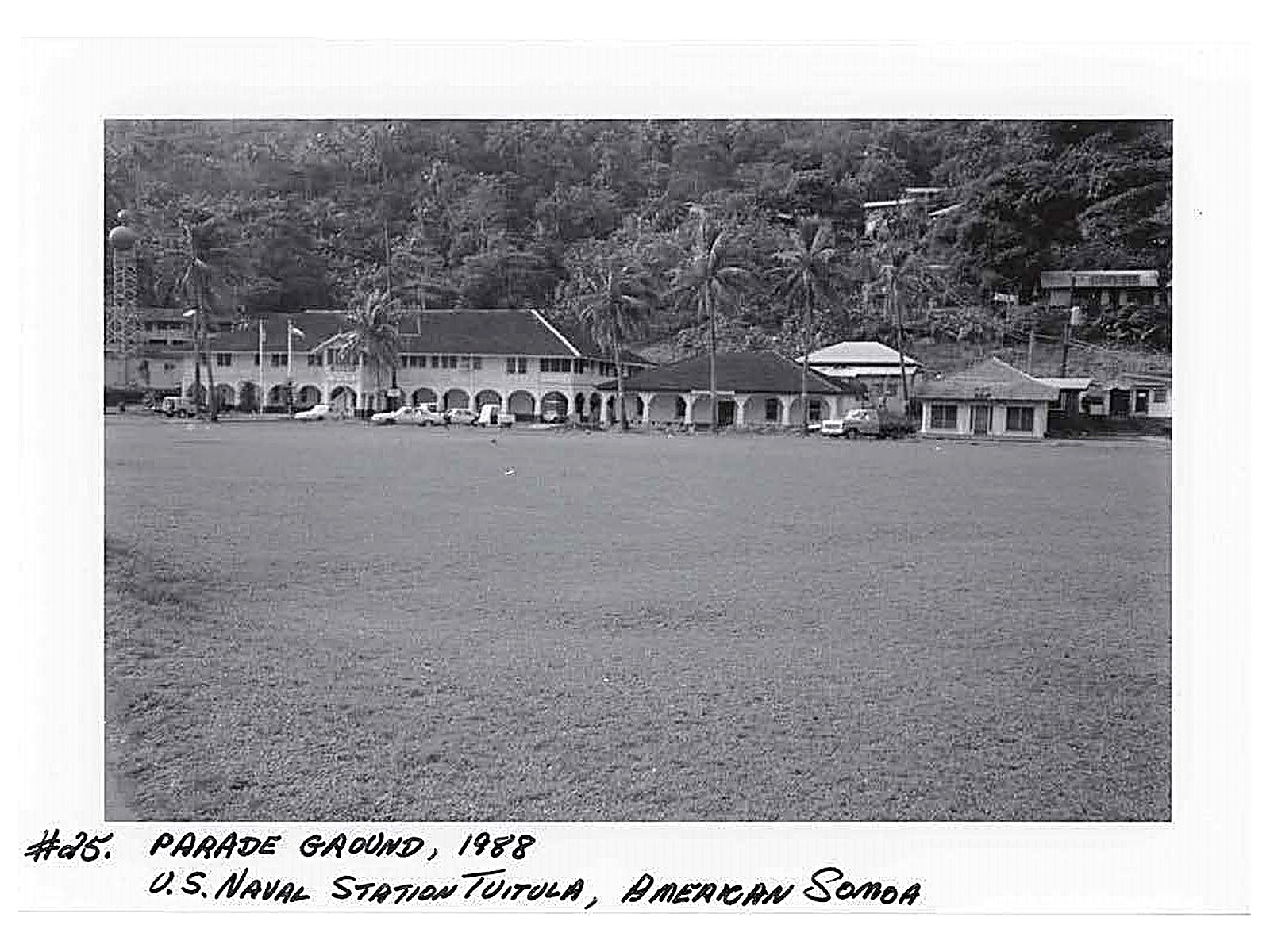 Parade ground with three buildings lining the backdrop of the photo.