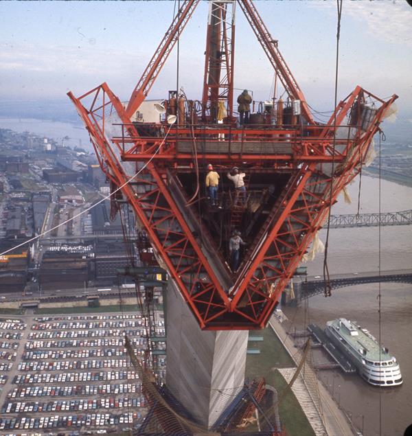 looking into one of the triangle shaped pieces of the Arch from high up, cars and river below