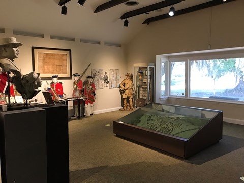 Museum exhibit area with information panels and large window