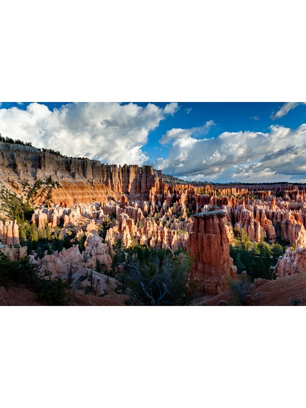 An overhead view of red rock formations with a blue sky in the background