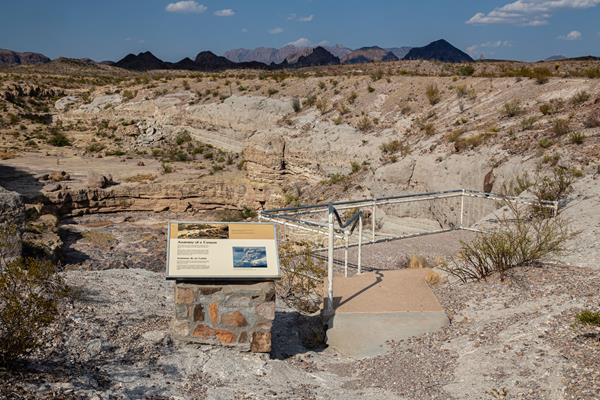 A wayside exhibit and viewing platform overlook the interior of Tuff Canyon.