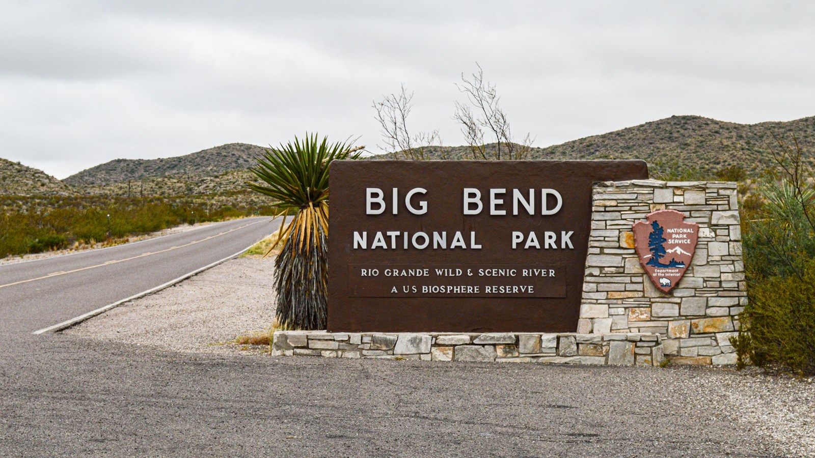 A stone and concrete sign with Big Bend\'s title sits adjacent to a paved vehicle pullout.