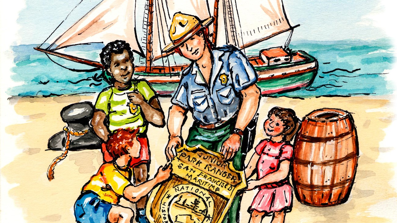 NPS Ranger with 3 kids around an enlarged Jr. Ranger Badge on a beach with a ship in the background 