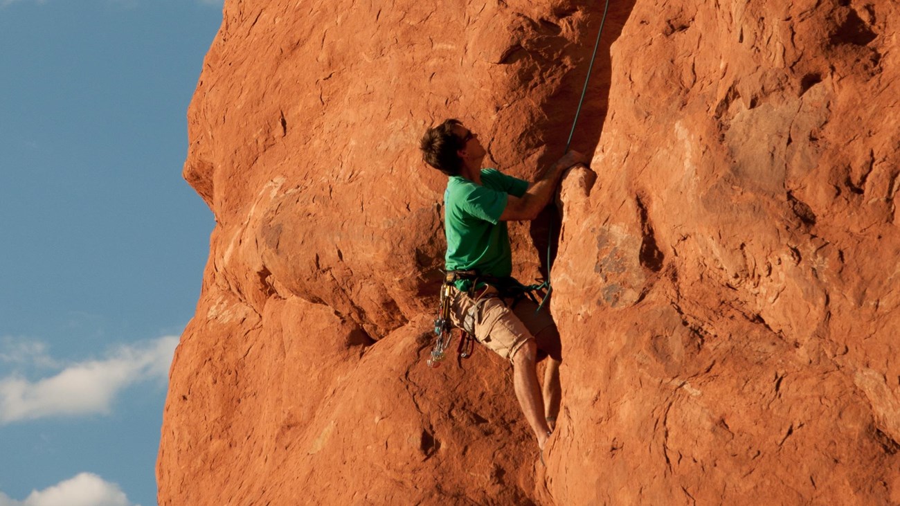 Climber ascends a crack in red sandstone