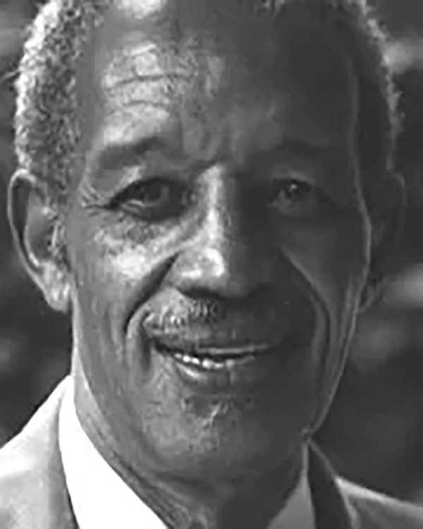 Black and white photo of an african american man with a thin face