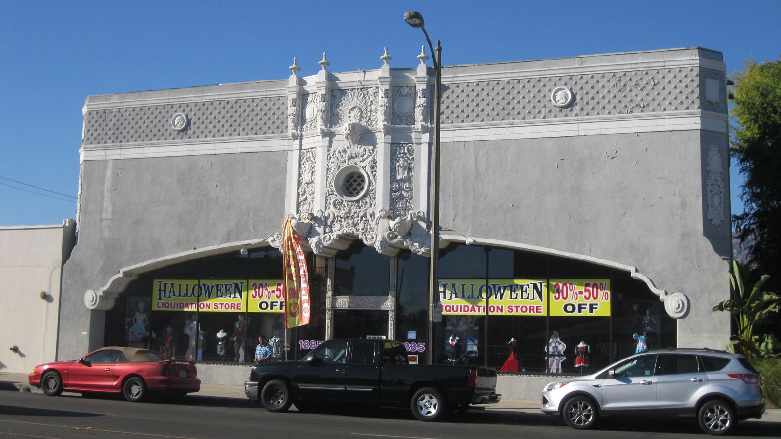 A grey and white tall building with ornate detailing. 
