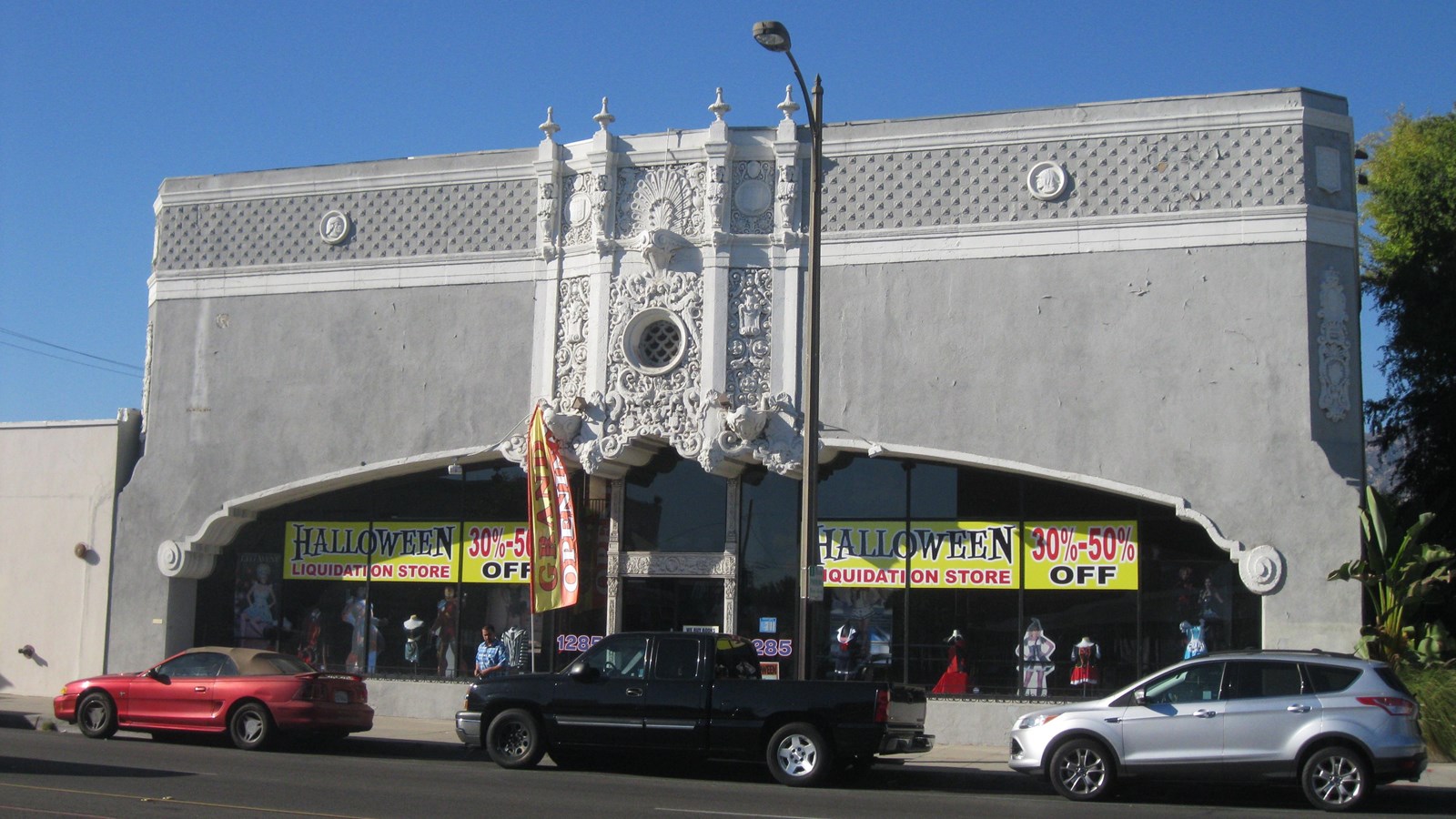 A grey and white tall building with ornate detailing.