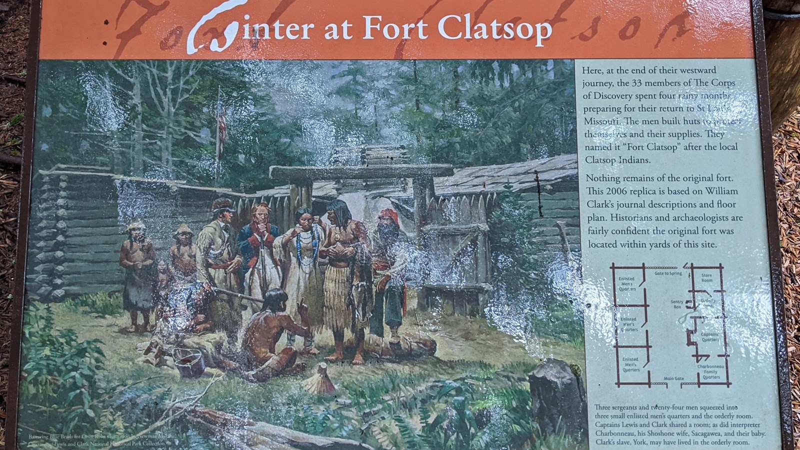 A close up photo of a sign, a painting depicts trading in front of the fort and the fort floorplans.