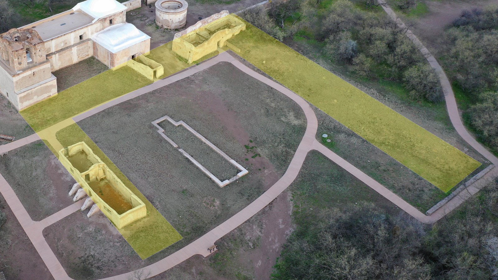 Aerial photo with U-shape outlined in yellow over existing mounds and above-ground ruins.
