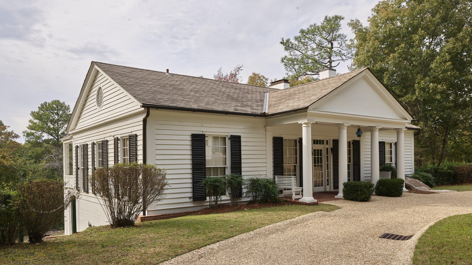 Moderate size white house with a columned portico reminiscent of the White House in front
