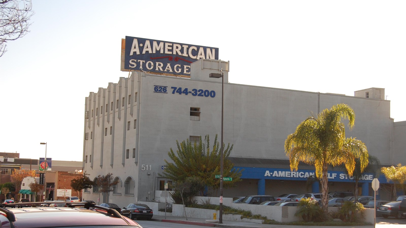 A white multi-story building with a sign on top that reads
