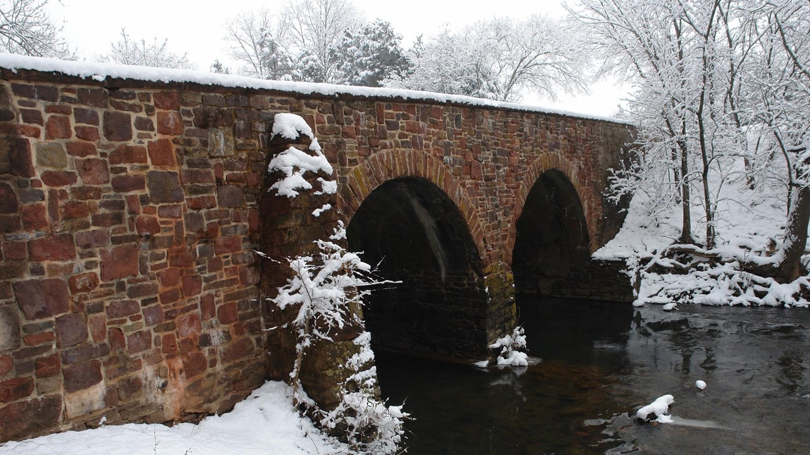 Stone Bridge with snow on it and the banks of Bull Run