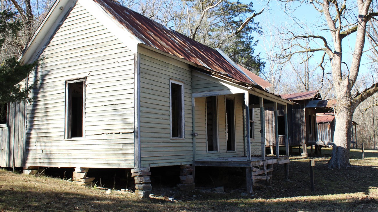 A weathered old house stands in the Rush Historic District.