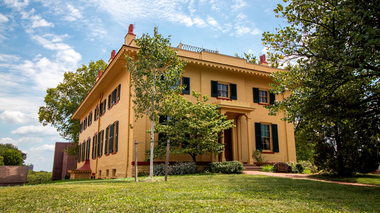 A large two-story yellow-bricked house