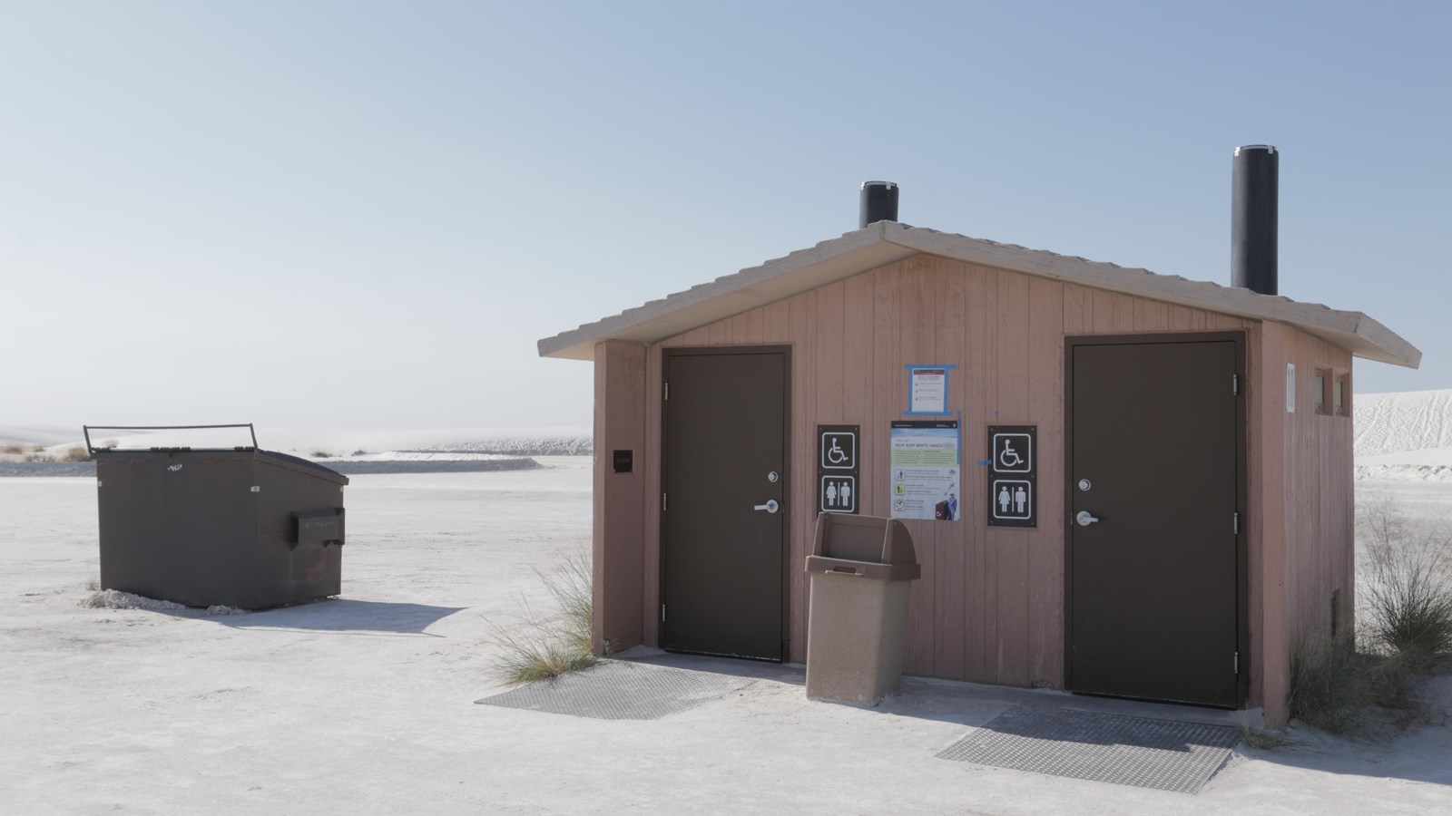 The Alkali Flat restroom, with its trash and dumpster receptacles.