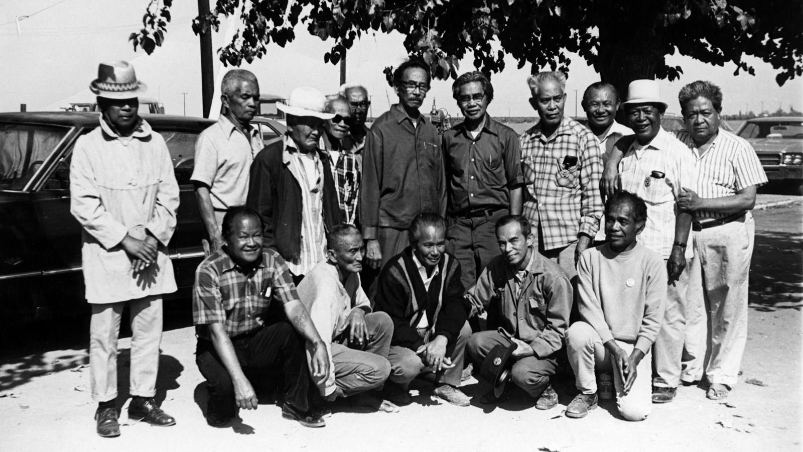 A black and white photo of a group of 16 men.