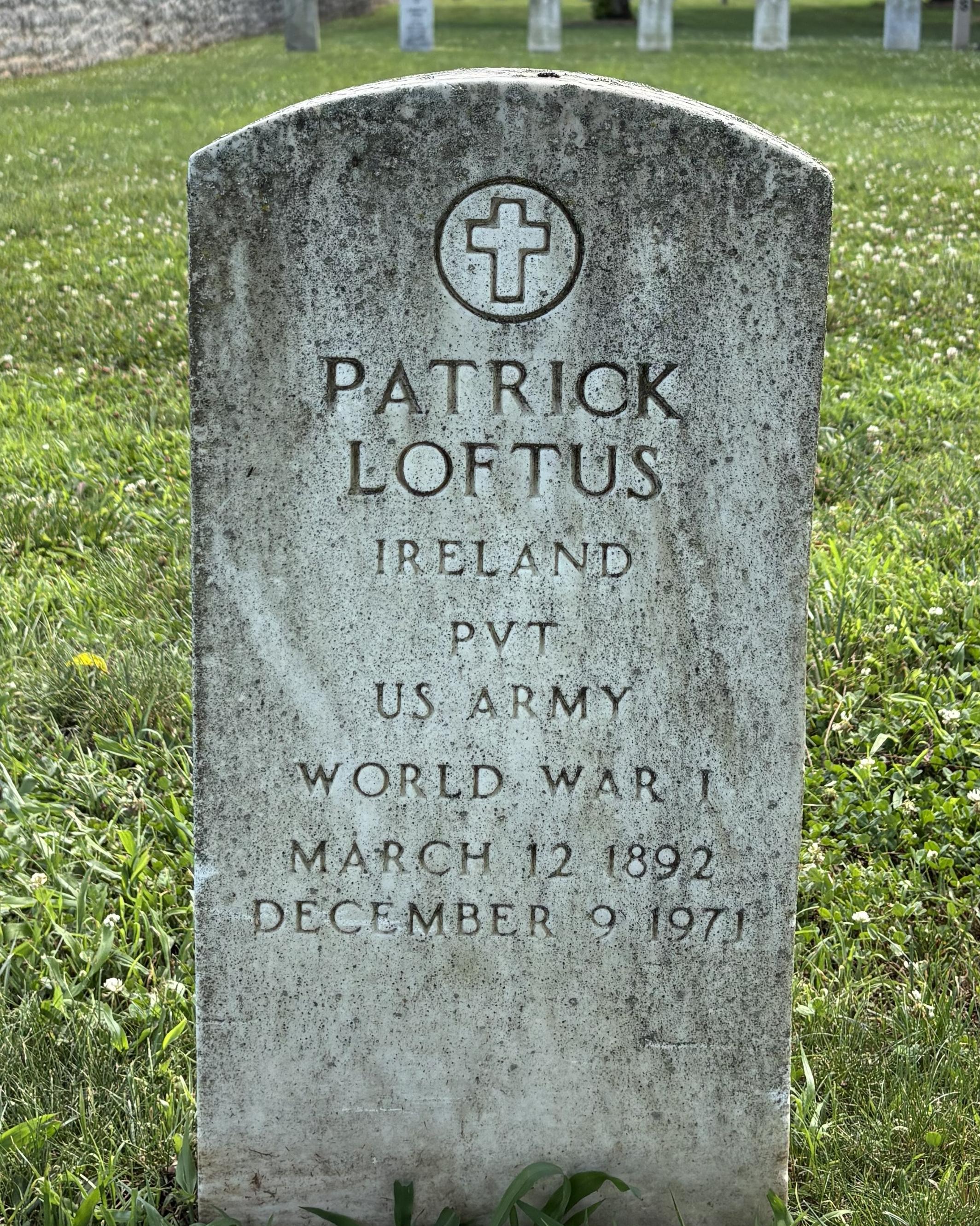 Marble headstone belonging to US Army veteran Patrick Loftus. 