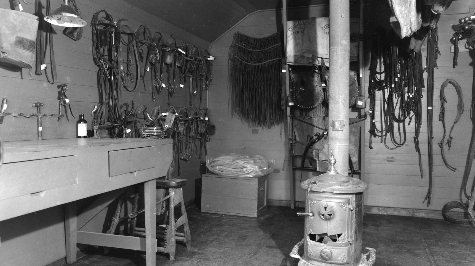 A black and white interior view of the tack room at Grant-Kohrs Ranch. 