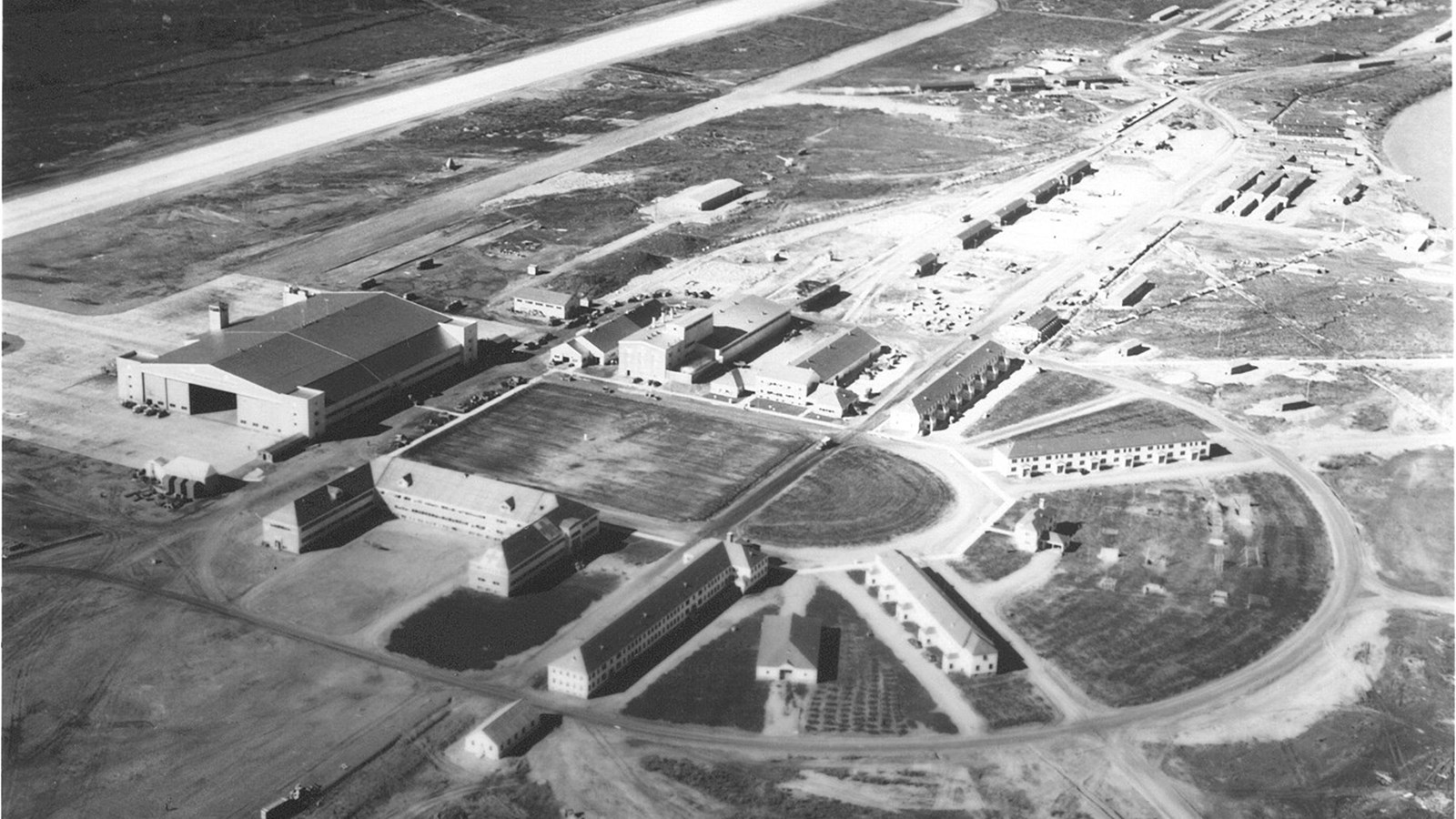 A historic aerial photo of Ladd Field hangars and runways