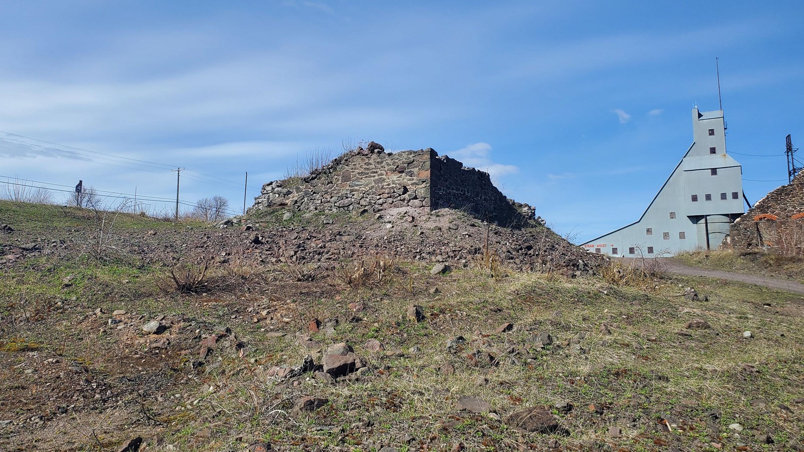 Spring scene of poor-rock building foundation.