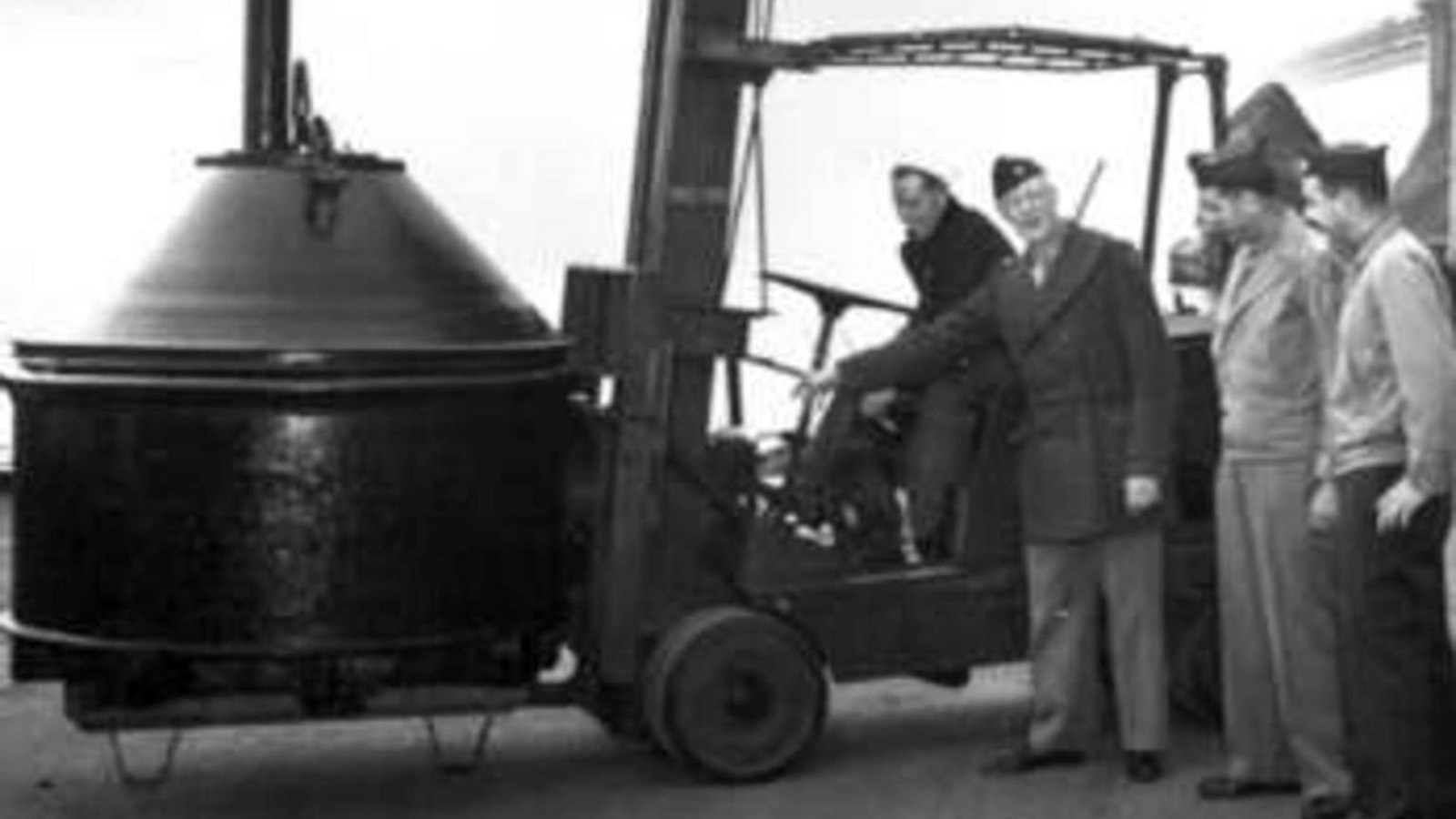 Soldiers moving an underwater mine with a fork lift. 