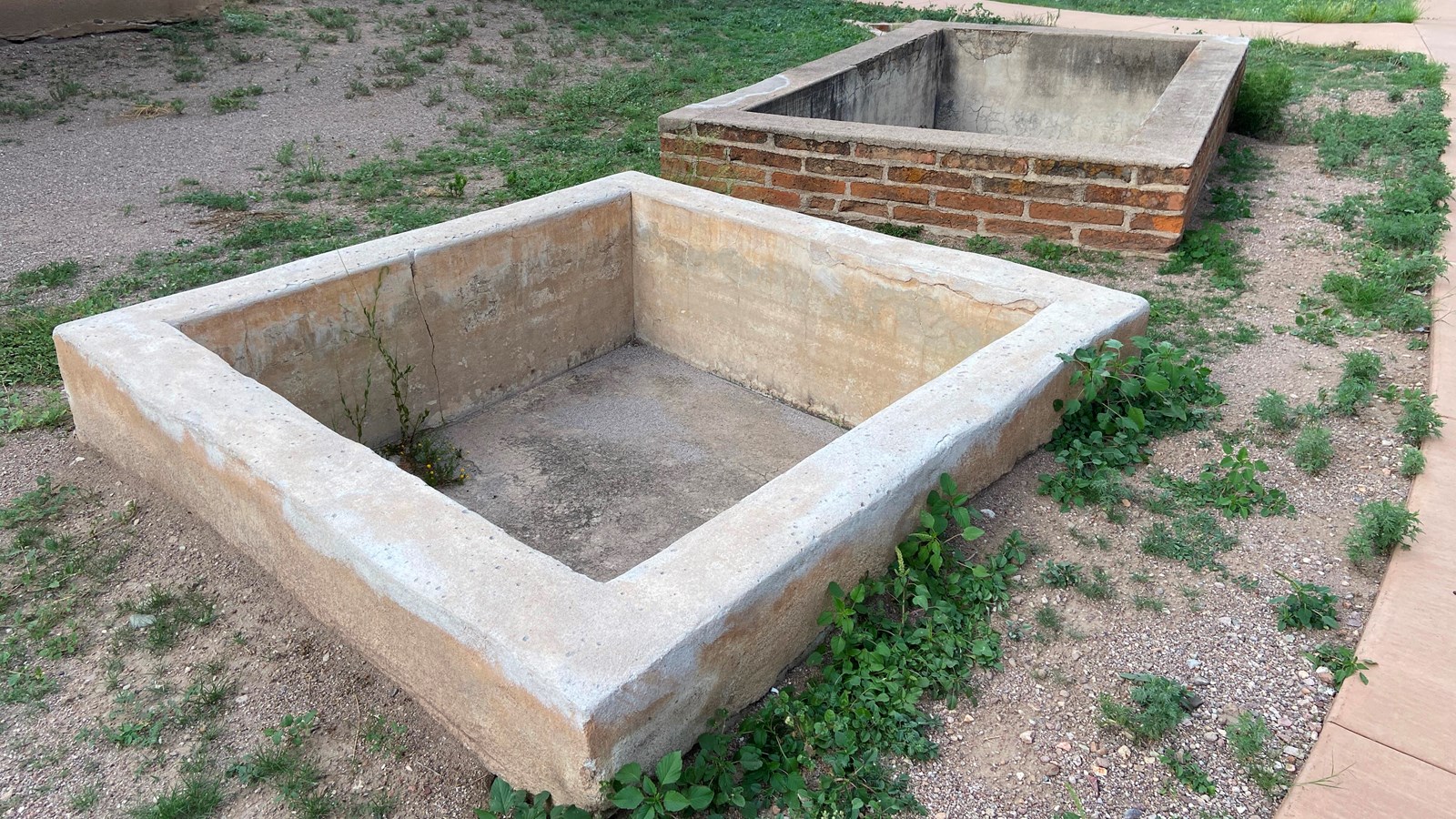 Two rectangular pits, lined with brick and plaster.