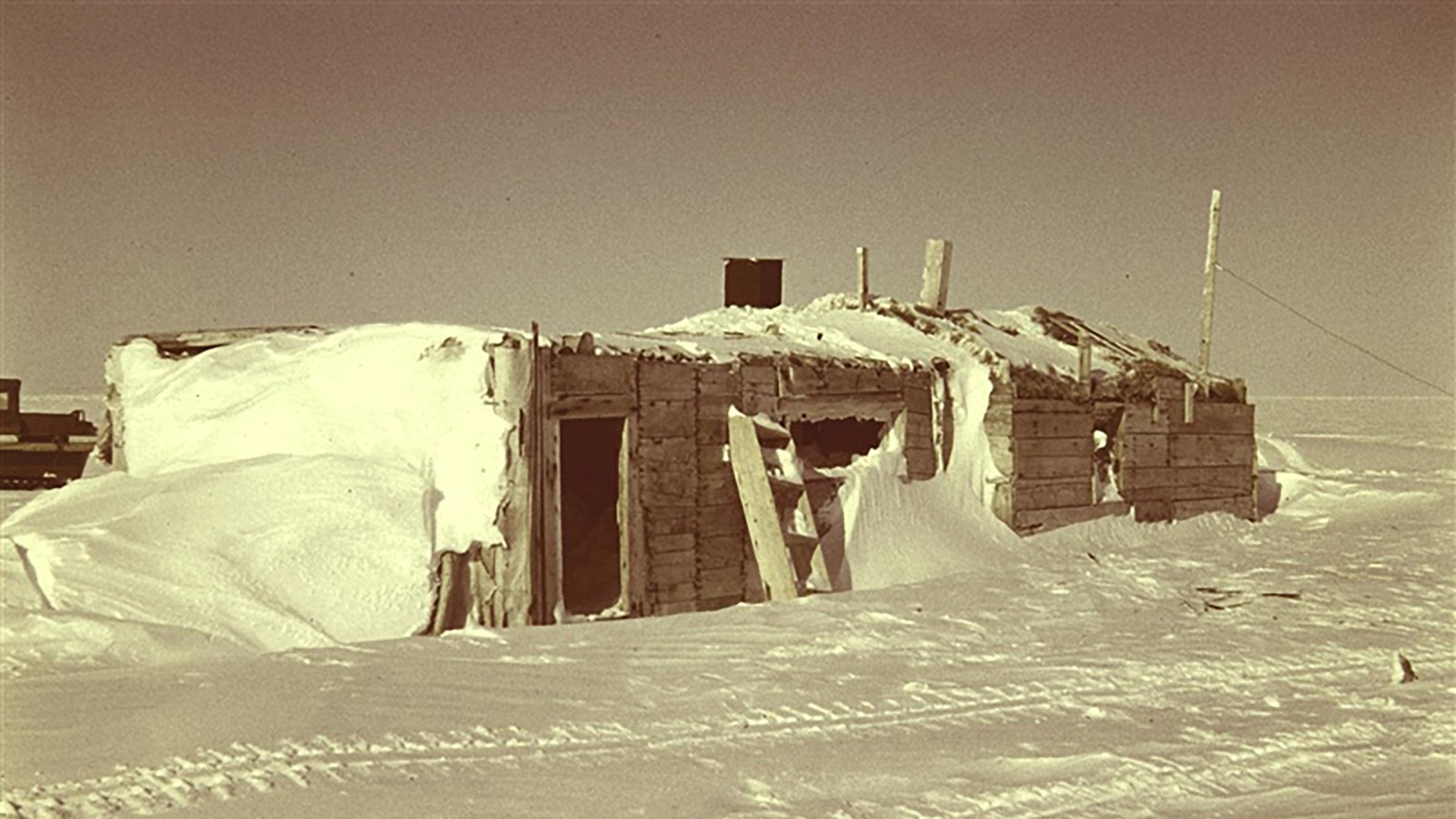 Historic photo of research cabins on a snowy landscape.