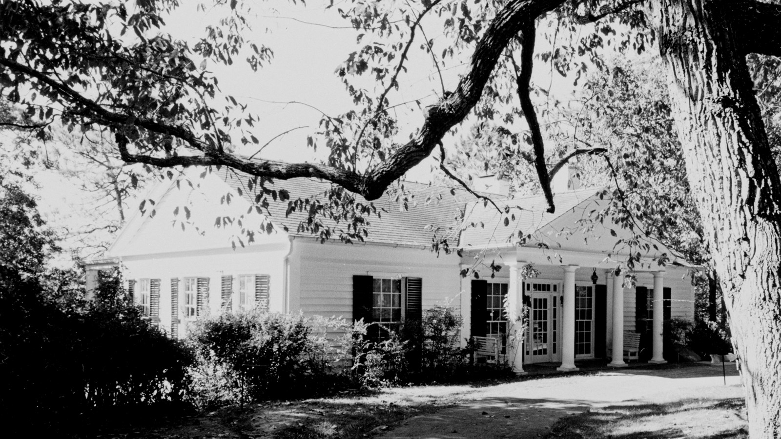 moderate sized house with a columned portico in the front