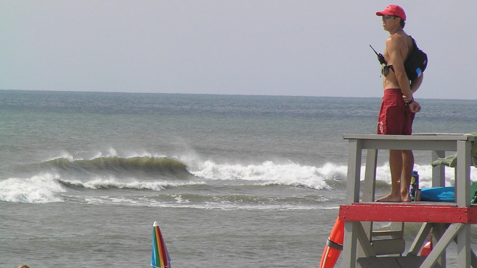 A lifeguard stands watch over the beach