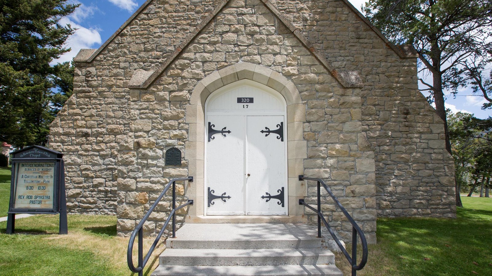 The front doors of a historic stone chapel building.