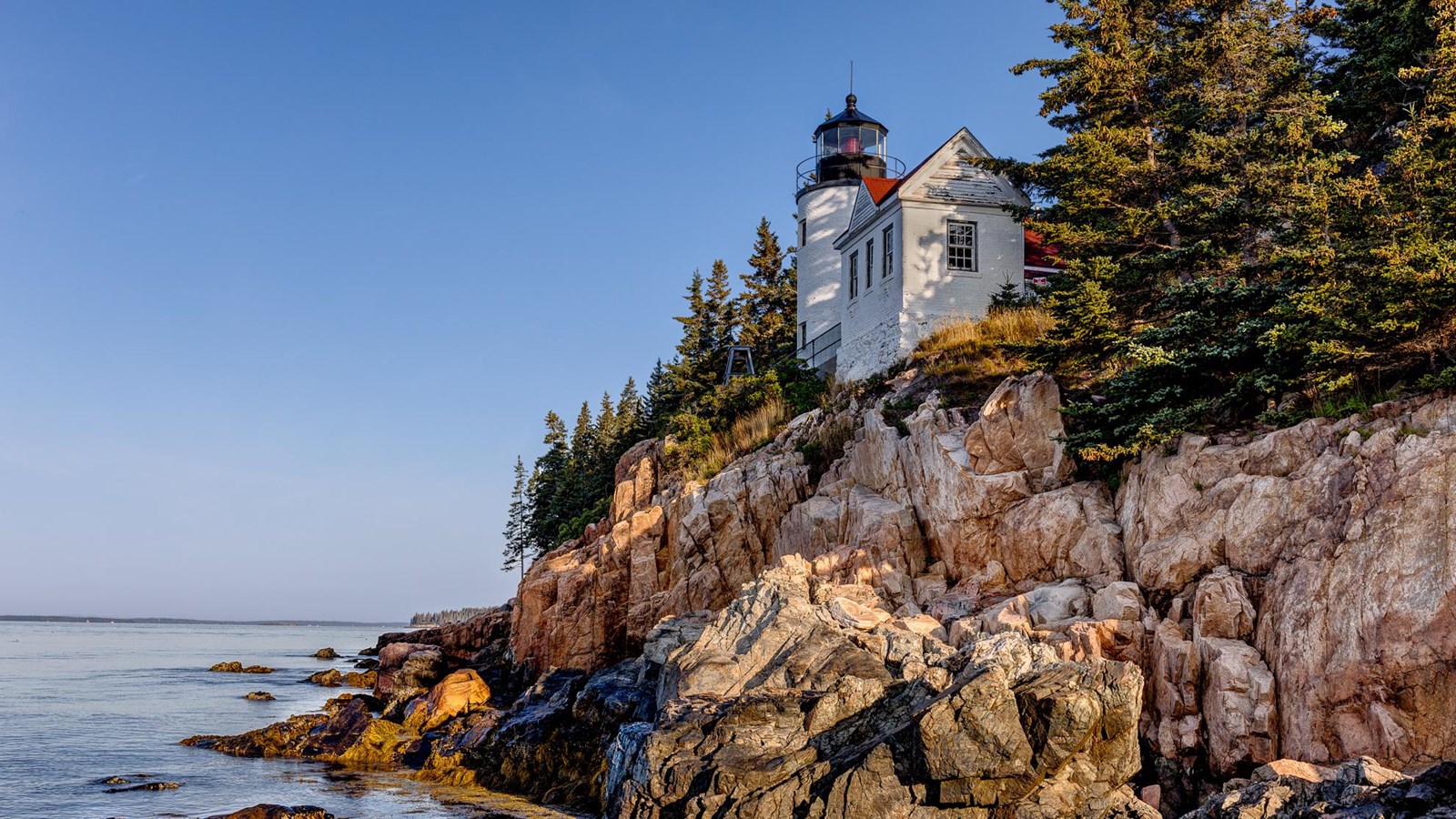 Image of lighthouse overlooking Acadia National Park Rocky Cliff side