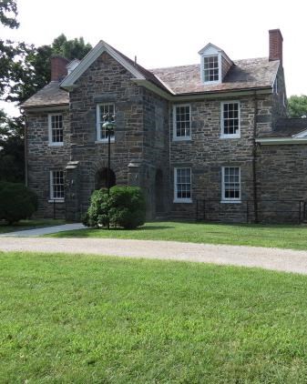 a three story stone structure with many windows