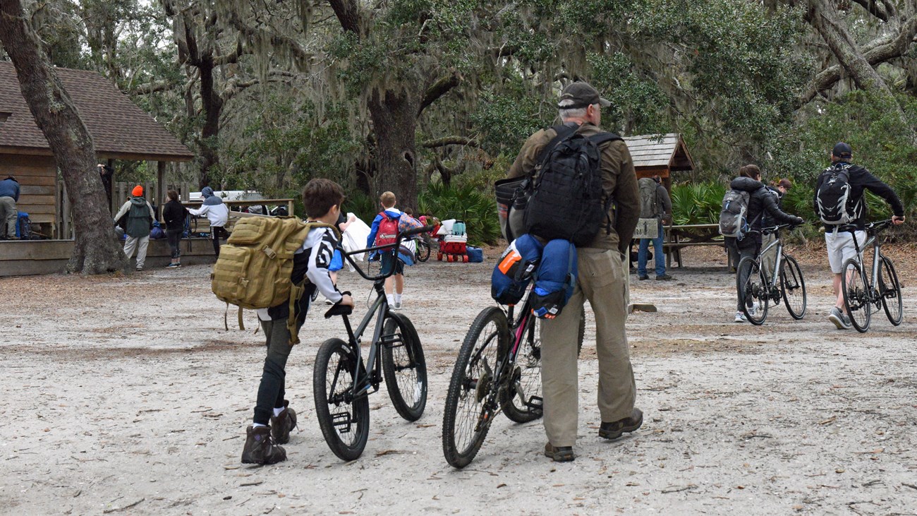 Visitors pushing thier bikes onto the island