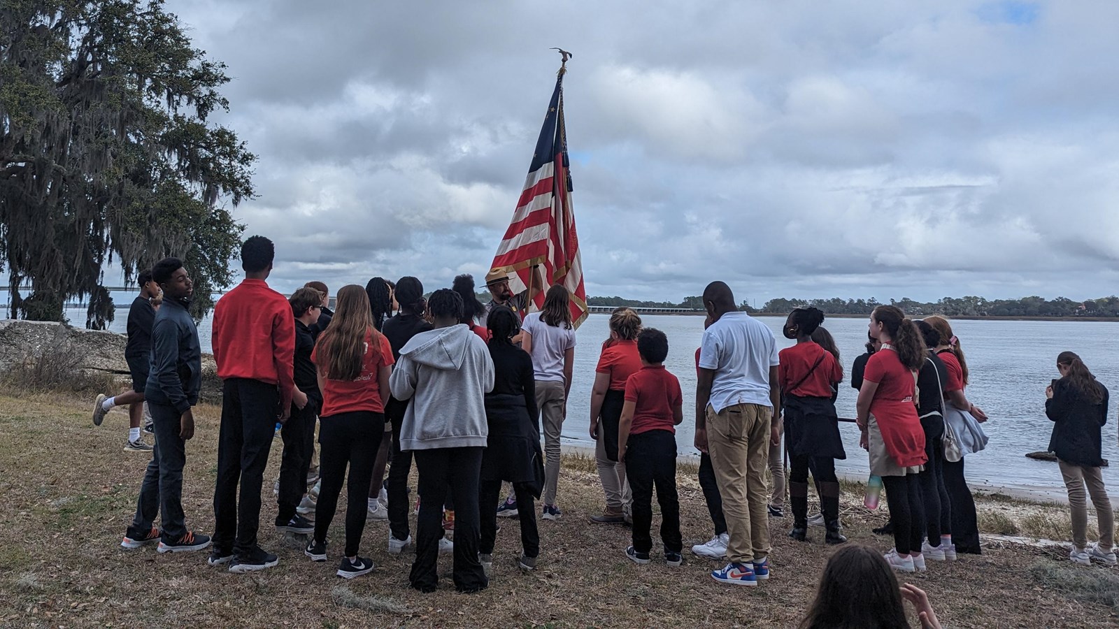 A ranger talks to a group of people in front of the marsh.