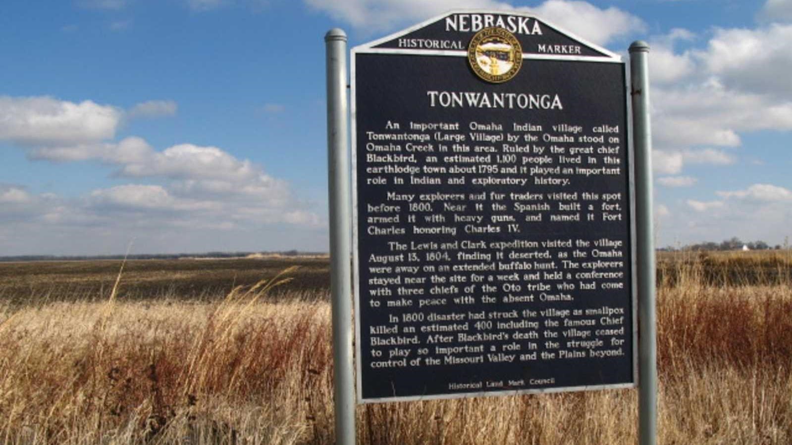 Large interpretive sign with prairie behind it