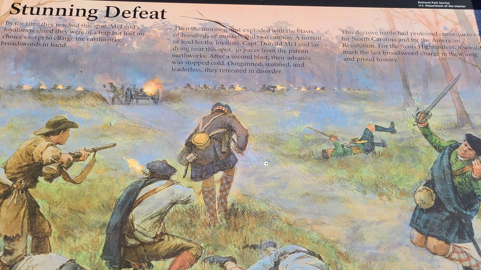 Metal Wayside sign with paintings of Loyalists falling on a field.