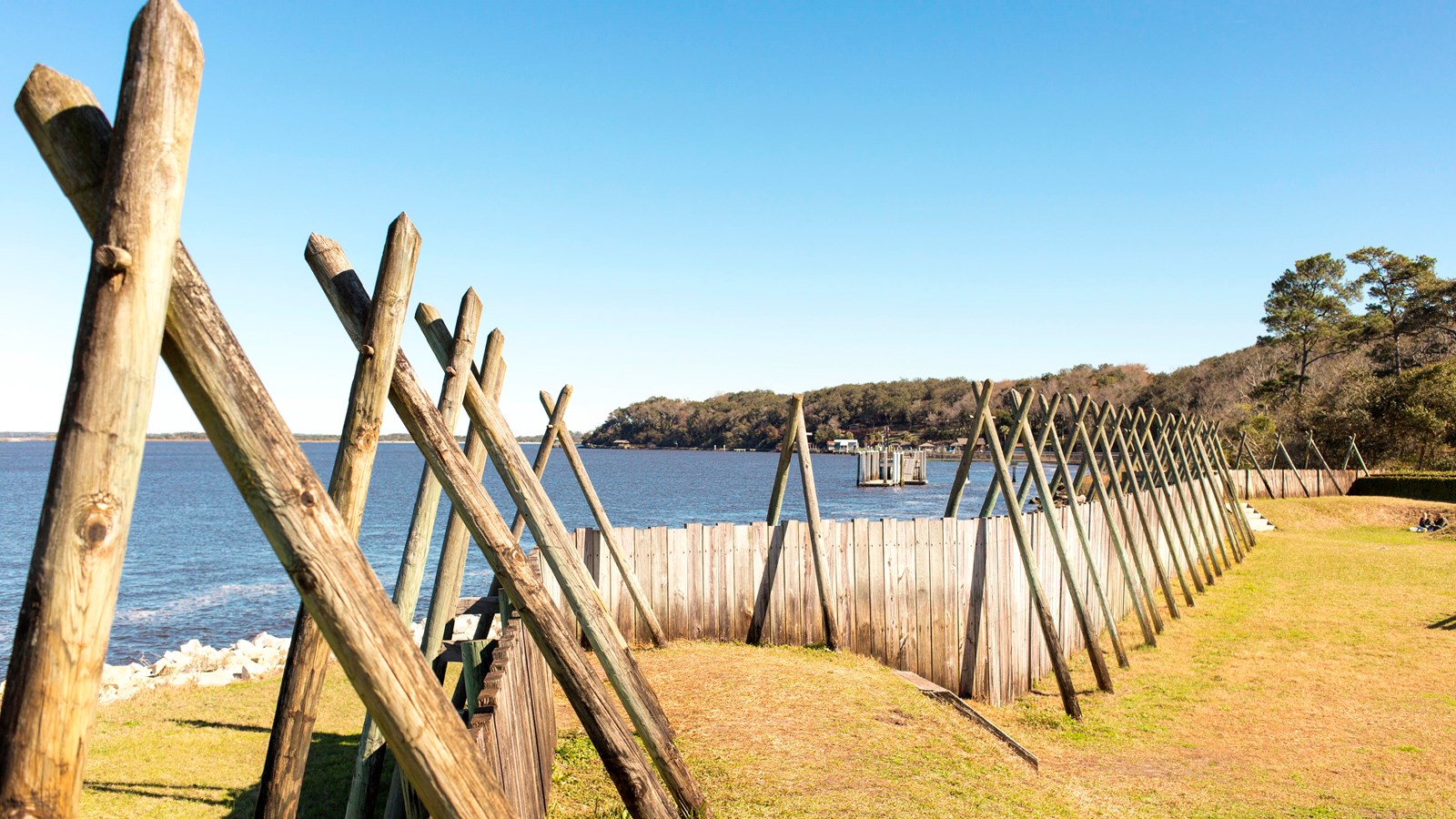 a wooden wall along the river