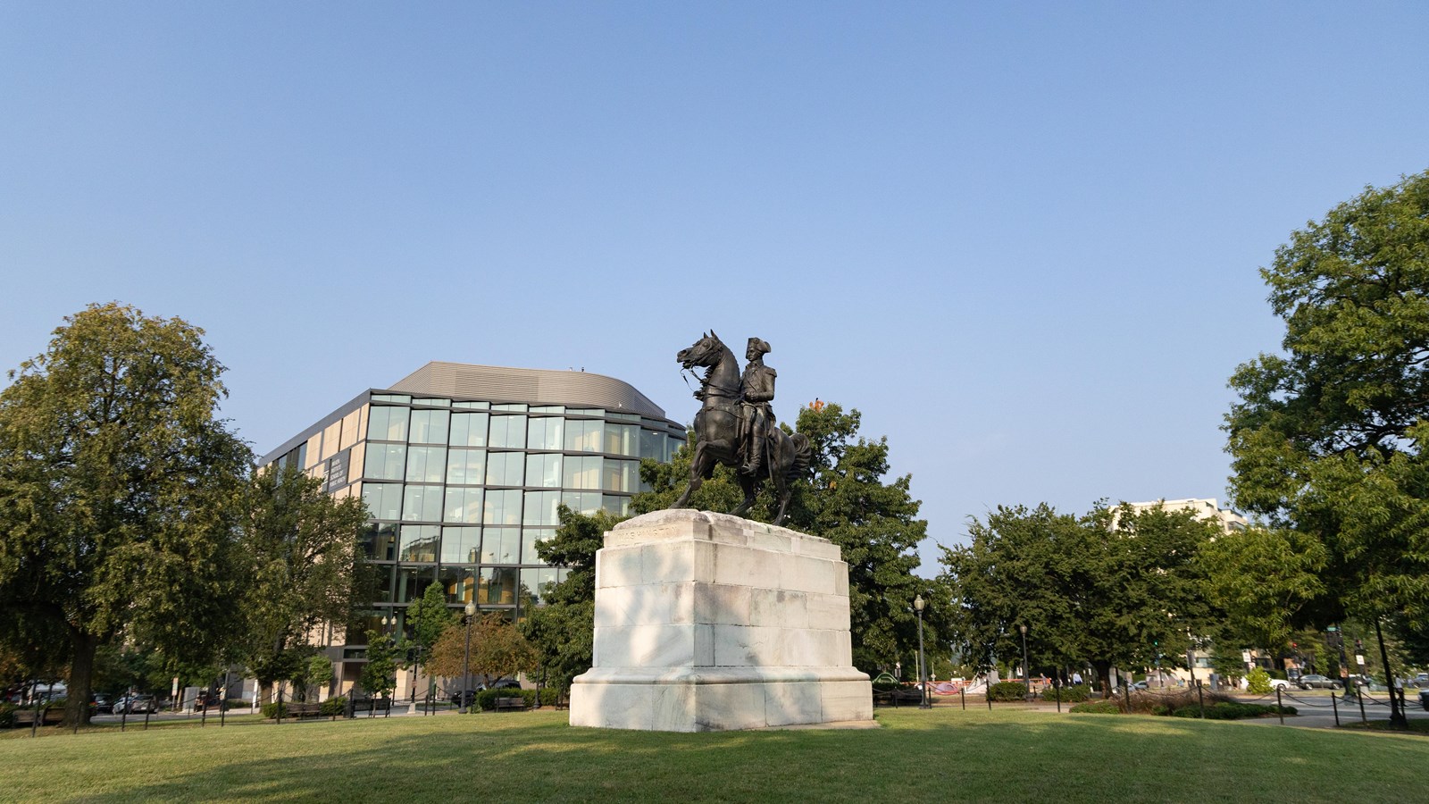 A statue of George Washington riding a horse in a park