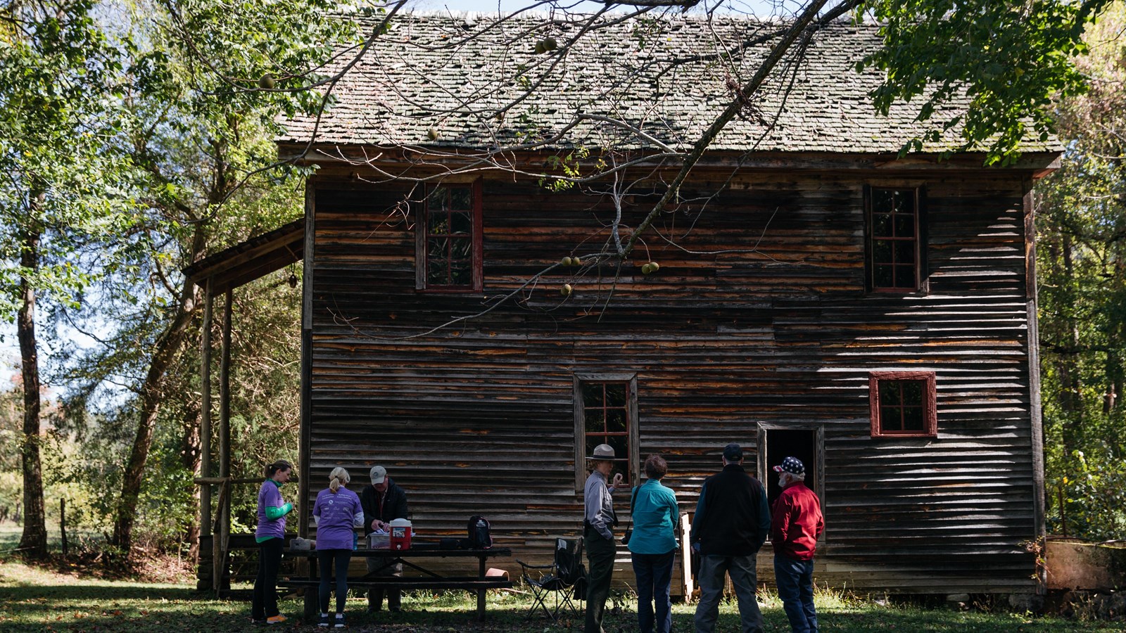 Visitors listen to a ranger outside of Boxley Mill. 