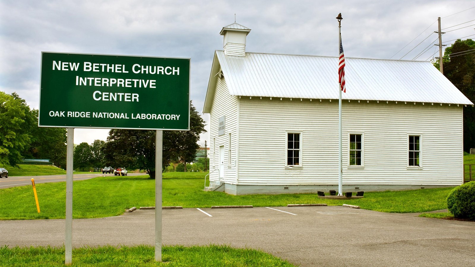 A small white church with a sign that reads “New Bethel Interpretive Center”.