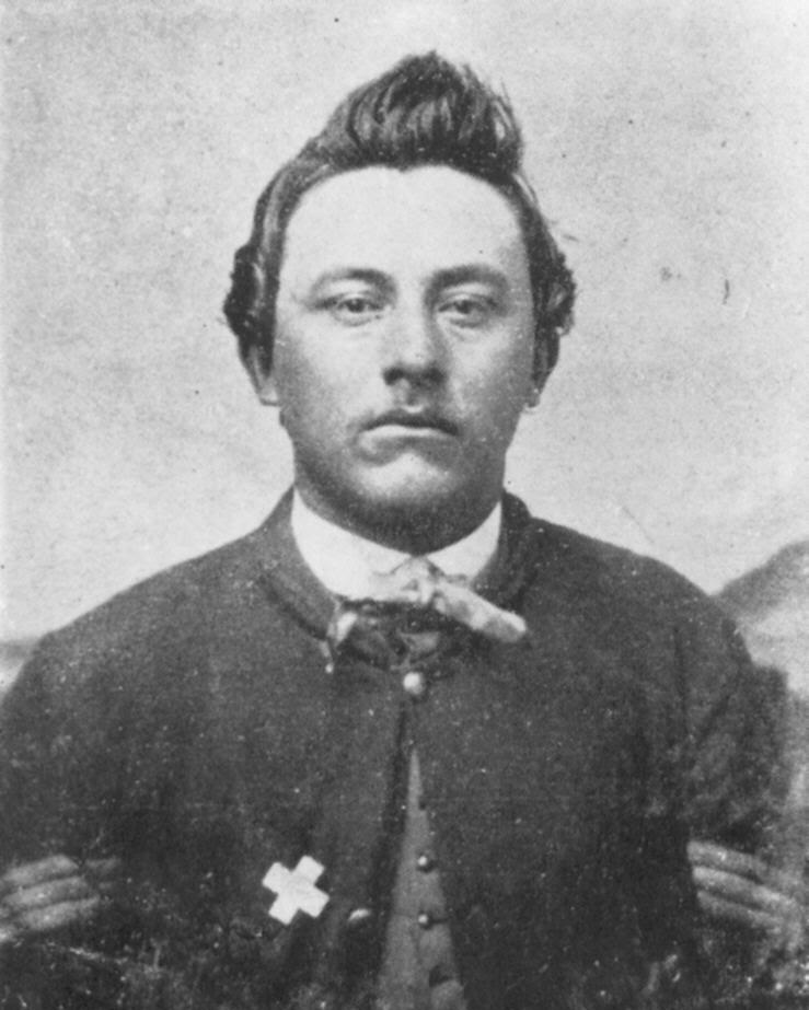 A Civil War soldier sits for a portrait photo. 