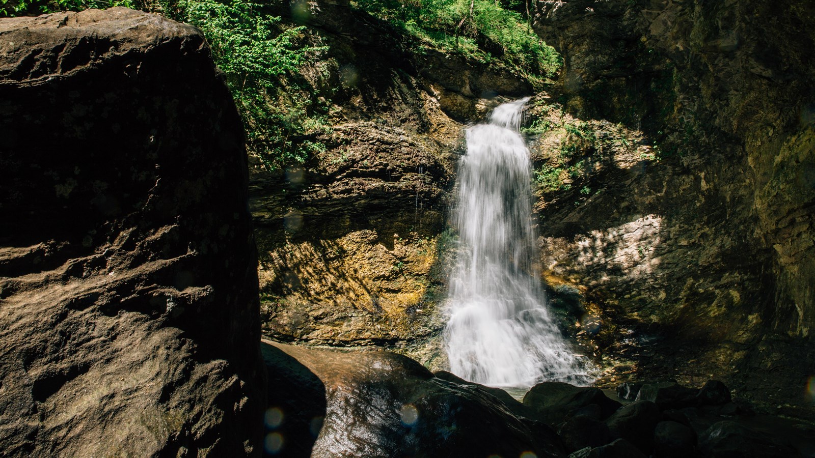 Water blurs as it tumbles over a cliff to form Eden Falls.